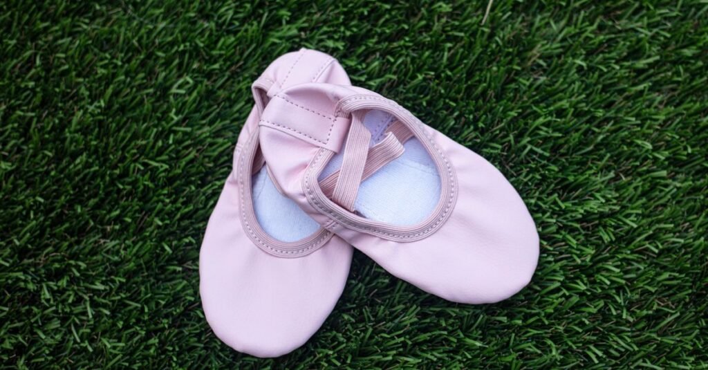 Pink ballet flats resting on green grass