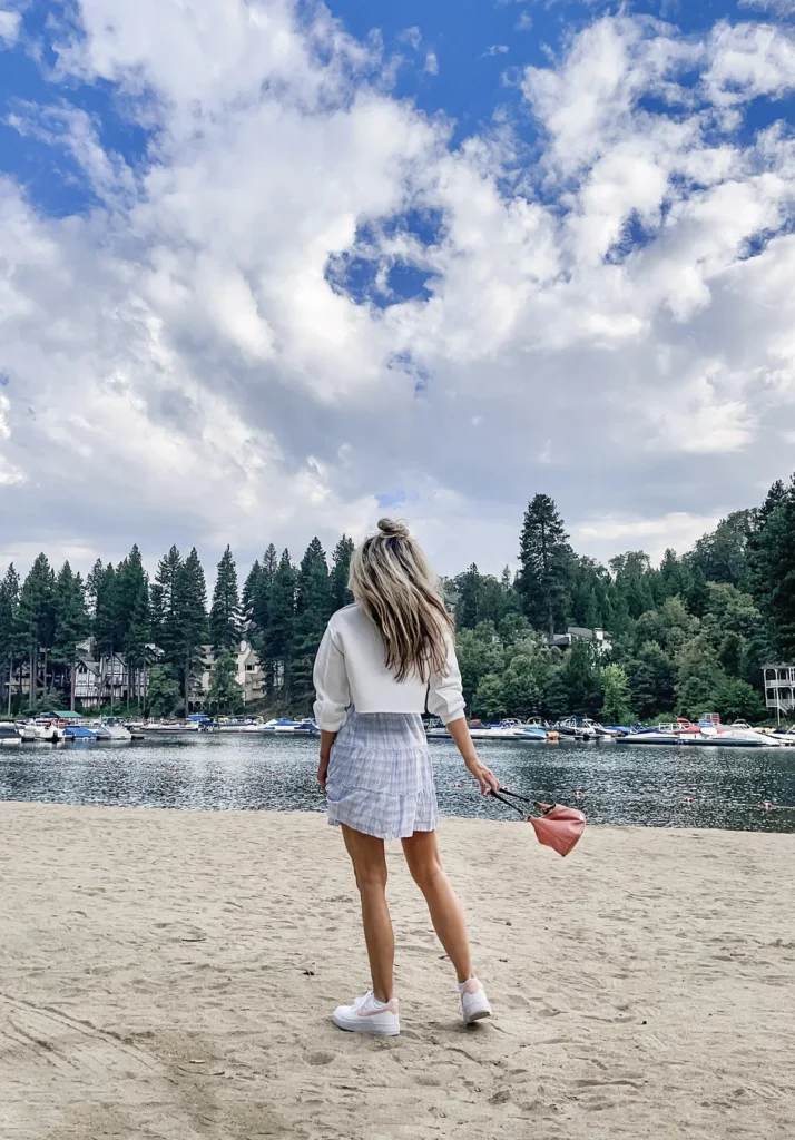 Pastel plaid dress outfit walking toward lake from behind