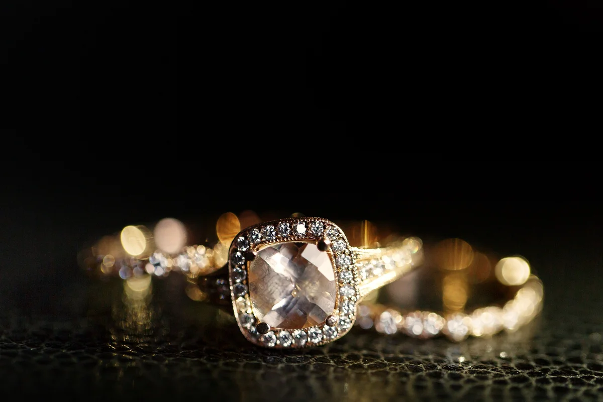 Close-up of an elegant diamond halo ring in warm metal