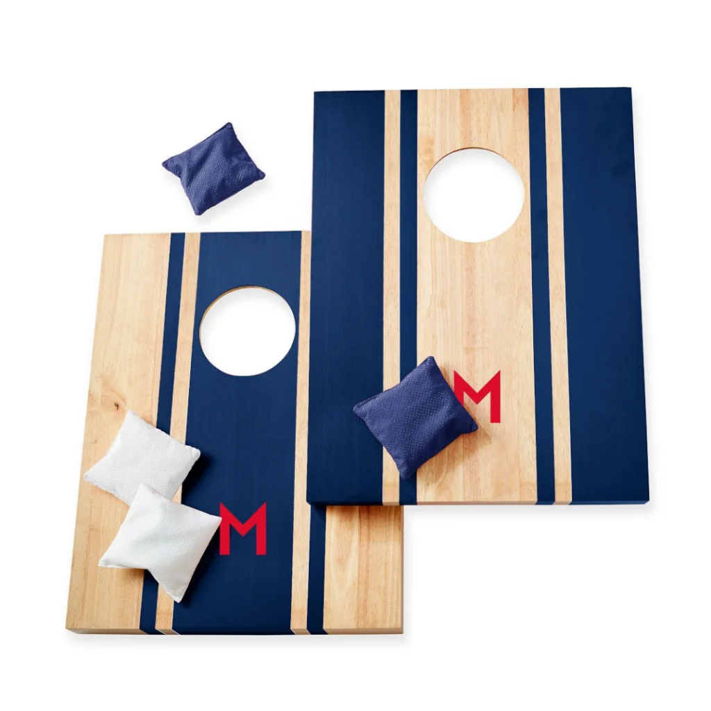 Two wooden corn hole boards with striped bean bags