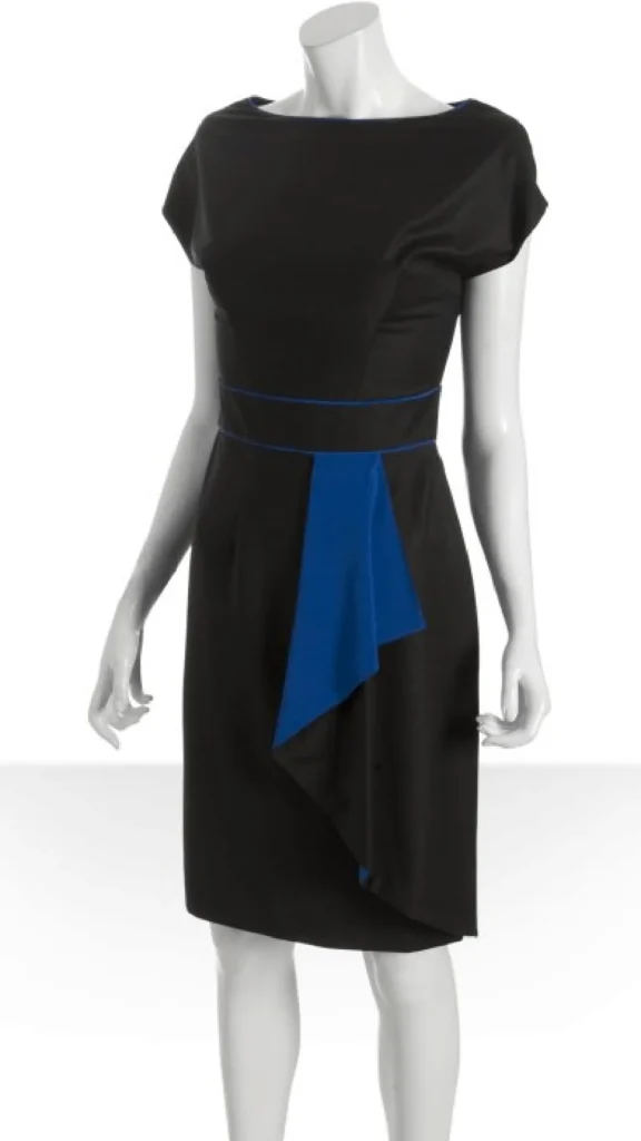 Black sheath dress with blue accent panel on a mannequin