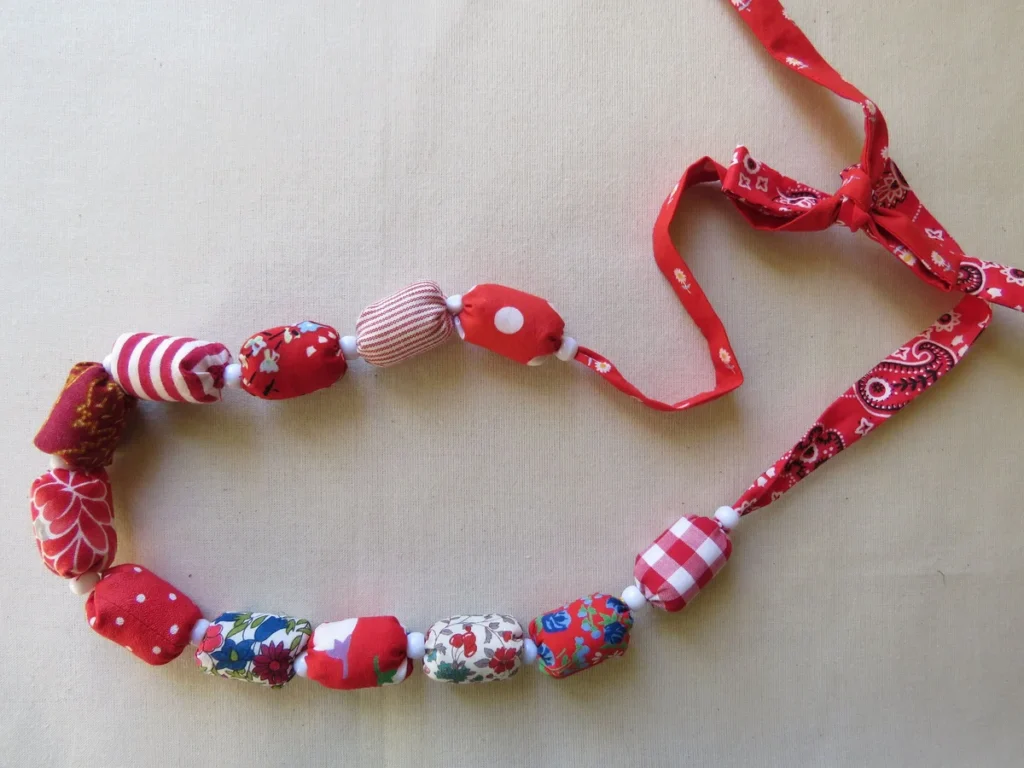 Finished handmade fabric necklace with red and white patterned beads