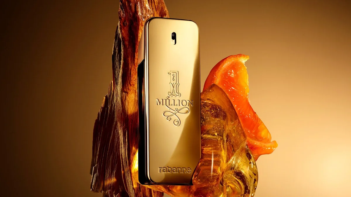 Gold bar-shaped 1 Million cologne bottle with citrus slice and amber resin