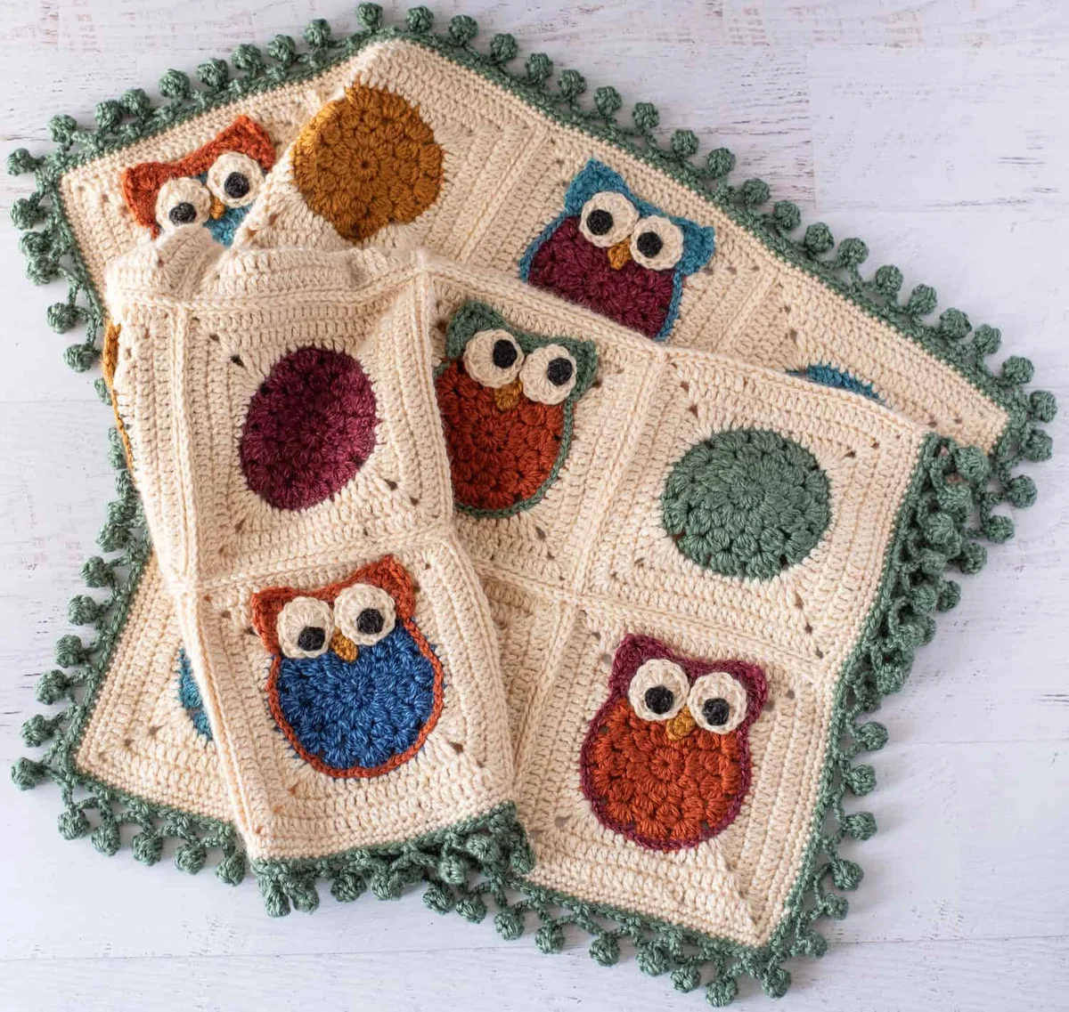 Finished crochet owl granny square blanket with pom pom border
