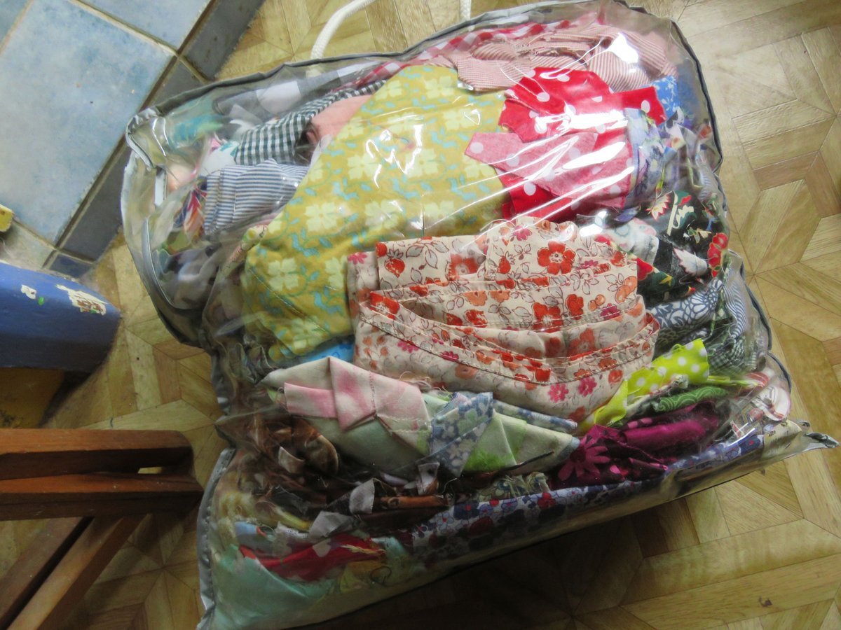Bag full of decades-old printed fabric scraps on wooden floor