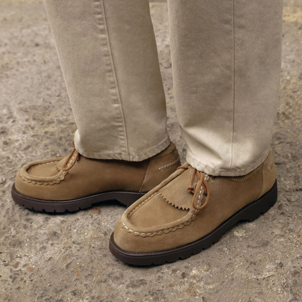 Tan moccasin-toe derby with chunky rubber sole on street