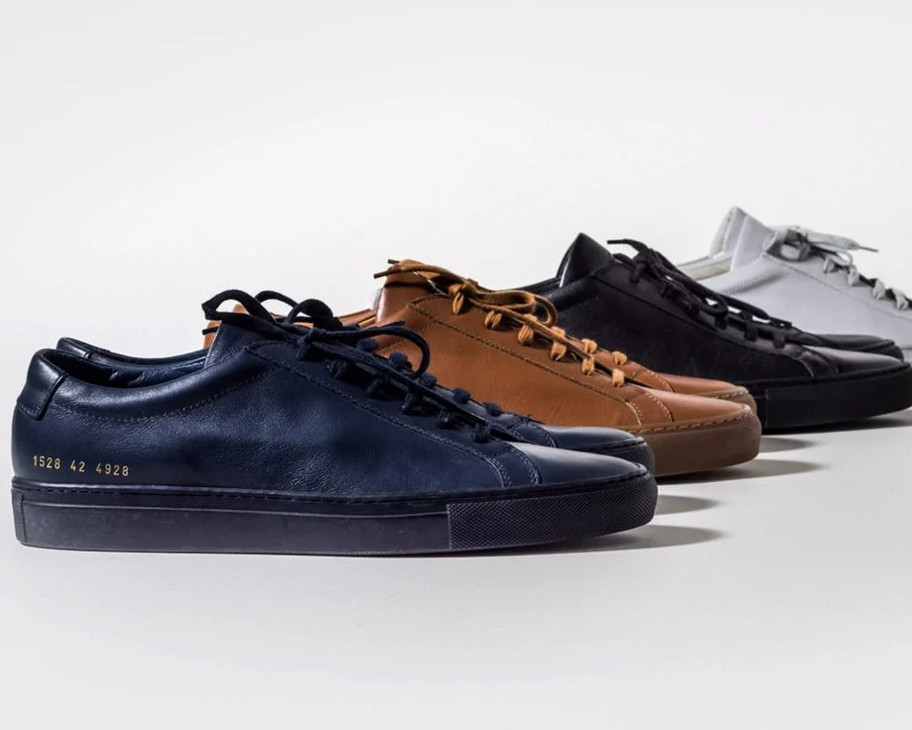 Minimalist leather sneakers in multiple neutral colours, studio shot