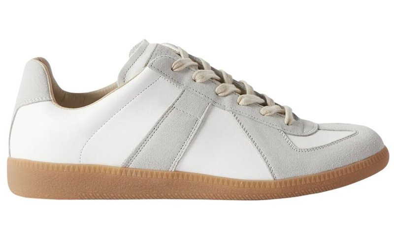 White minimalist sneaker with gum sole on neutral background