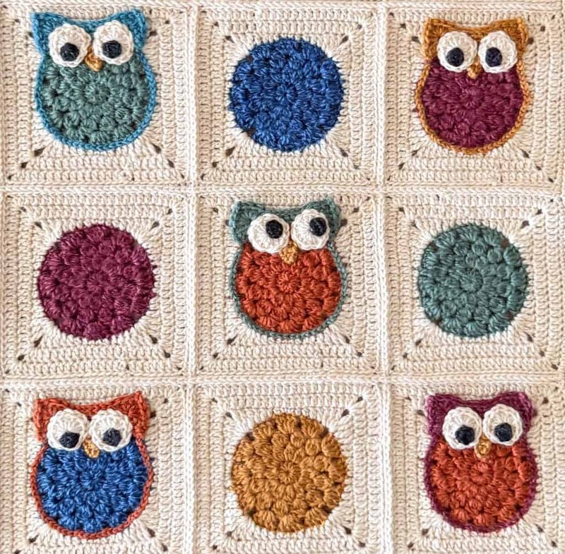 Owls positioned to look at each other on the crochet afghan