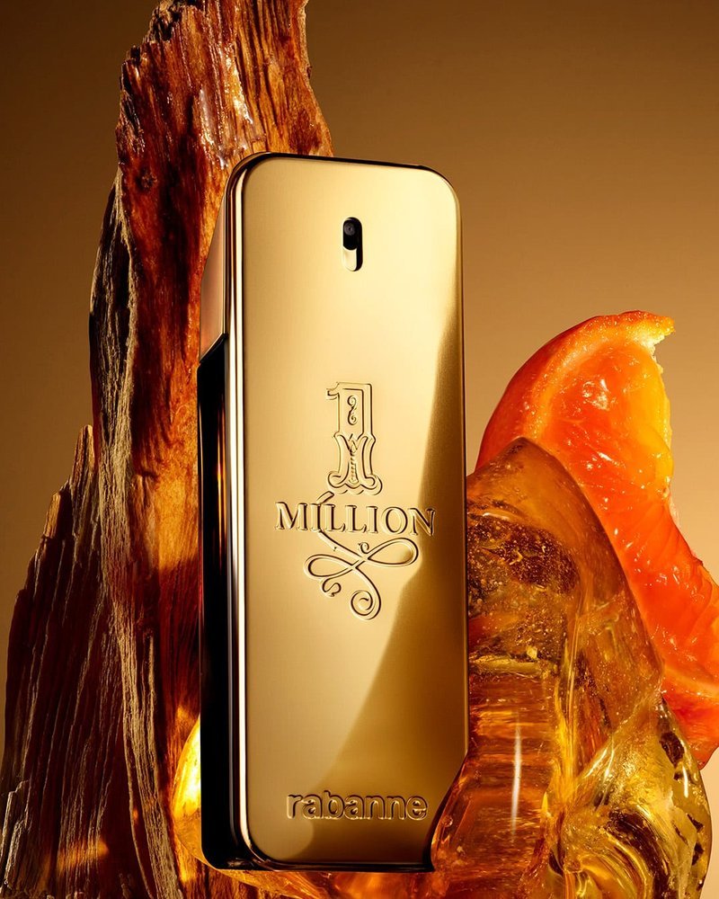 Gold 1 Million cologne bottle styled with driftwood and orange slice