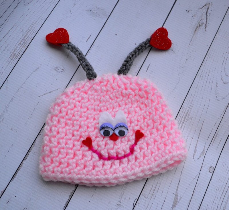 Fully assembled crochet love bug hat with face details