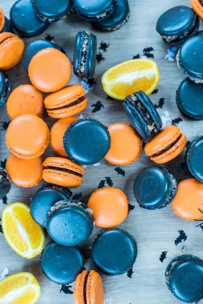 Macarons and lemon slices on a wooden table